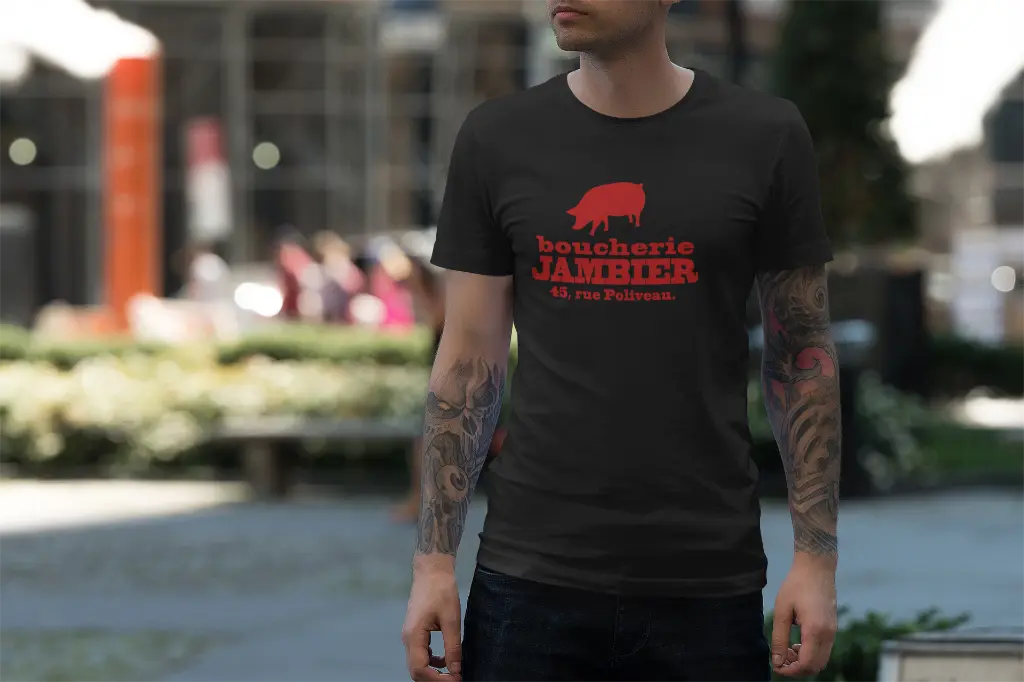Boucherie_Jambier_tee-mockup-featuring-a-man-with-tattooed-arms-on-the-street-3362-el1.webp